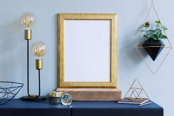 Interior  poster mock up with vertical gold frame, table lamp, accessories and hanging plants in...
