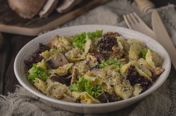 Homemade tortellini with mushrooms and walnuts