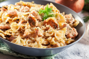 Creamy farfalle pasta with salmon, parmesan cheese and dill