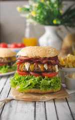 Homemade bacon burger with lettuce and cheddar