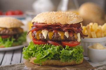 Homemade bacon burger with lettuce and cheddar