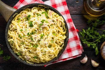 Pasta carbonara with bacon and cream sauce top view. 