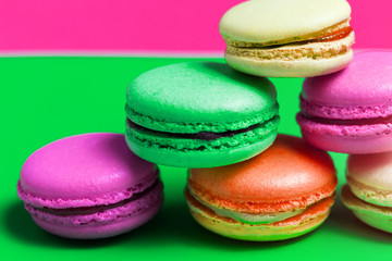 Closeup of colorful pink, orange, green. beige French sweet macaroons on the table
