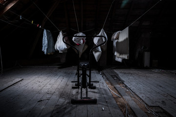 Fototapeta na wymiar training bicycle and washing in the attic of an abandoned villa
