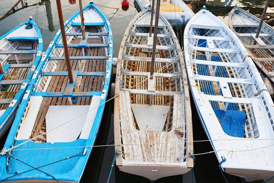 Multi-colored vintage boats near the marina