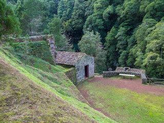 Nature Reserve park Parque Natural da Ribeira dos Caldeiroes at Achada with historic water mills, houses, antique equipment, waterfalls, Lavada - irrigation canals, tree fern garden. Nordeste, Sao