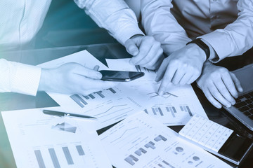 Men's hands with calculator and phone on the background of the documents on the table