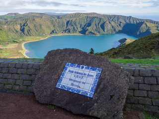 View on beautiful blue crater lake Lagoa do Fogo from viewpoint miradouro da barrosa. and sign on...