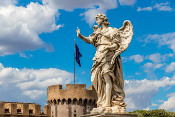 Obraz premium Statue of an angel on the background Castle Sant'Angelo and flag of european union, Rome, Italy