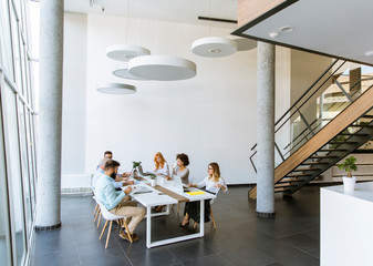 Joyful multiracial business team at work in modern office