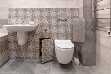 Fototapeta na wymiar interior of modern bathroom with bath, shower and toilet, hidden communications.