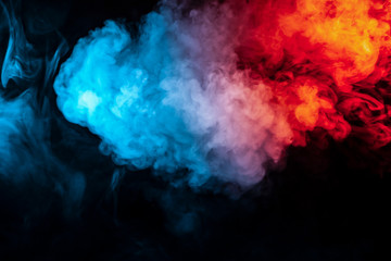 Clouds of isolated colored smoke: blue, red, orange, pink; scrolling on a black background in the...