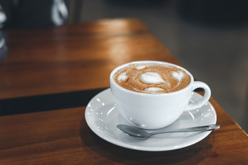 Coffee cup on old wooden table with copy space