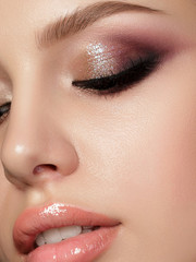 Closeup portrait of young beautiful woman with evening make up. Multicolored smokey eyes. Luxury...