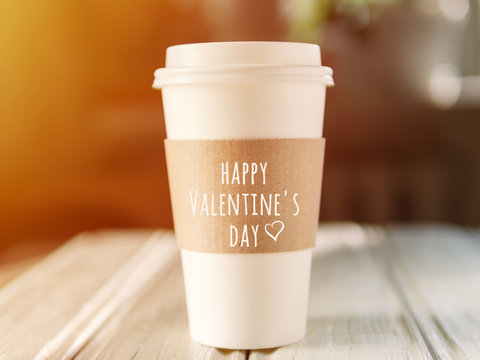 Fototapeta Wish you a happy Valentine's day on a paper Cup of coffee