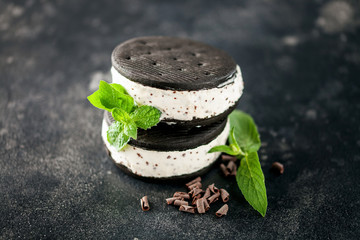 Ice cream  between black cookies.