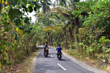 Motobikes driving on the road in Nusa Penida Island, Indonesia, Asia