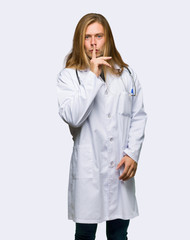 Doctor man showing a sign of silence gesture putting finger in mouth on isolated background