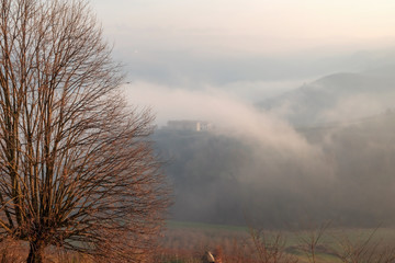 Langhe hills winter foggy panorama. Color image