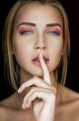 Naklejka premium Beautiful young woman. Blonde hair. Beauty portrait. Blue eyes. Look at the camera. Shoot at the studio. Beautiful Girl.