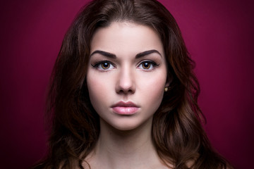 Fototapeta premium Studio Portrait of Young Brunette Woman with Perfect Skin on Pink Background