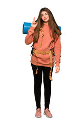 Naklejka premium Full-length shot of Hiker girl with fingers crossing and wishing the best on isolated white background