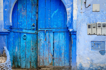 Traditional and typical moroccan blue door in Chefchaouen, Morocco, Africa.