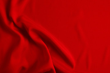 Red silk or satin luxury fabric texture can use as abstract background. Top view