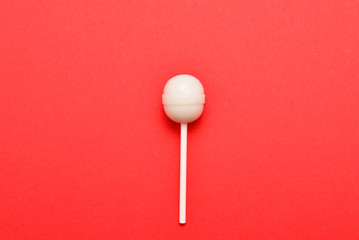 Lollipop on a red background. Space for text or design.