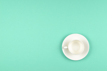 Empty cup on green background