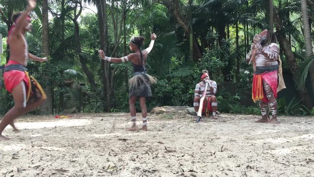 Indigenous Australian's People dancing to didgeridoo musical instrument sound rhythm in Queensland, Australia.
