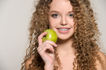 Healthy, beautiful smile, cute teen  with dental braces smiling . Portrait of a girl with...
