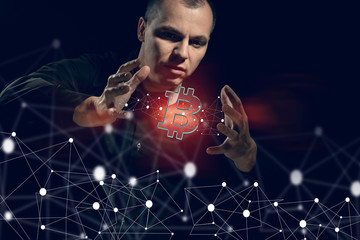 The projection currency is bitcoint and the concept of making. A man on a black background plays...