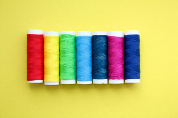 Color threads on yellow background