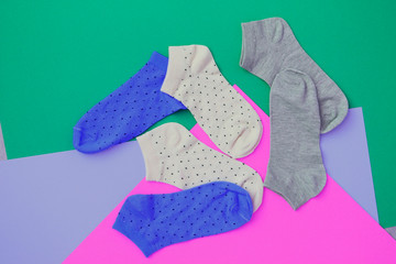 Socks on color background