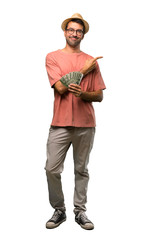Man holding many bills pointing to the side to present a product on isolated white background