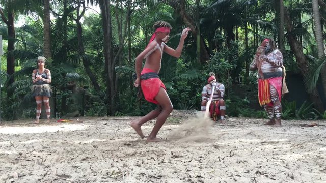 Indigenous Australian's People dancing to didgeridoo musical instrument sound rhythm in Queensland, Australia.