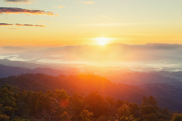 The view of the sunrise on the mountain in cold weather with fog in the mountains