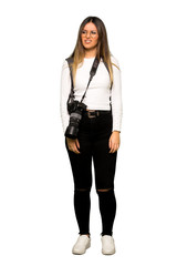 Full body of Young photographer woman is a little bit nervous and scared pressing the teeth