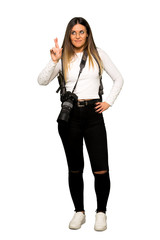 Full body of Young photographer woman with fingers crossing and wishing the best