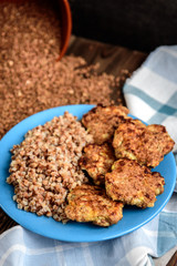 Grilled chicken with buckwheat on blue plate. Healthy dinner