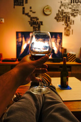 Chilling at home with fireplace on tv and red vine in hand