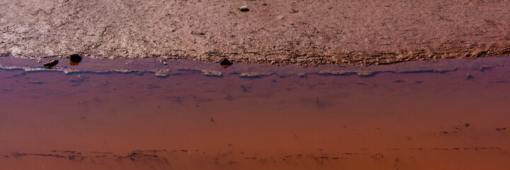 contaminated water and soil with iron oxides in the industrial zone.  Banner for design.