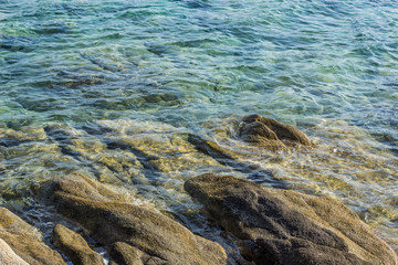 sea stone rocky coast shoreline tropic background landscaping wallpaper scenic pattern of transparent blue water surface 