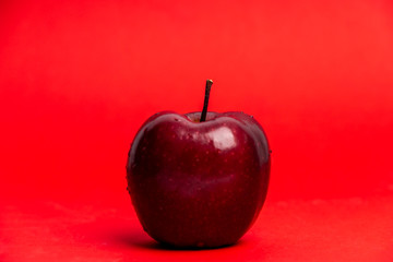 red apple isolated on red