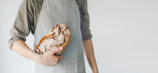 Baker or chef holding fresh made bread