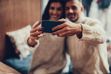 Two person making selfie photo on telephone