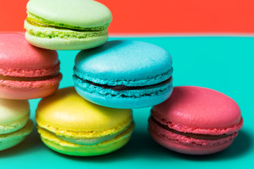 Colorful macarons cakes on a blue background, closeup