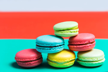 Cake macaron or macaroon on turquoise background, colorful cookies, pastel colors