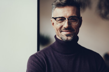 Obraz premium Man is looking in camera and smiling
